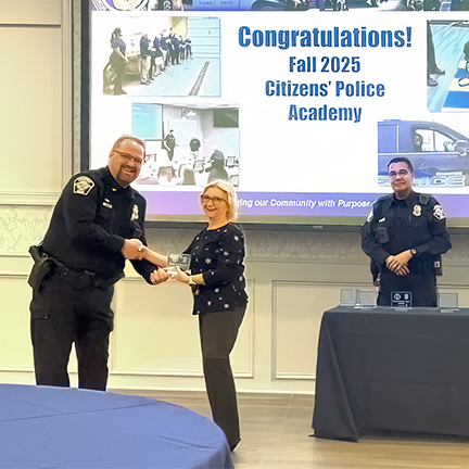 Jeanie receiving award from Chief of Police for completing Citizens Police Academy
